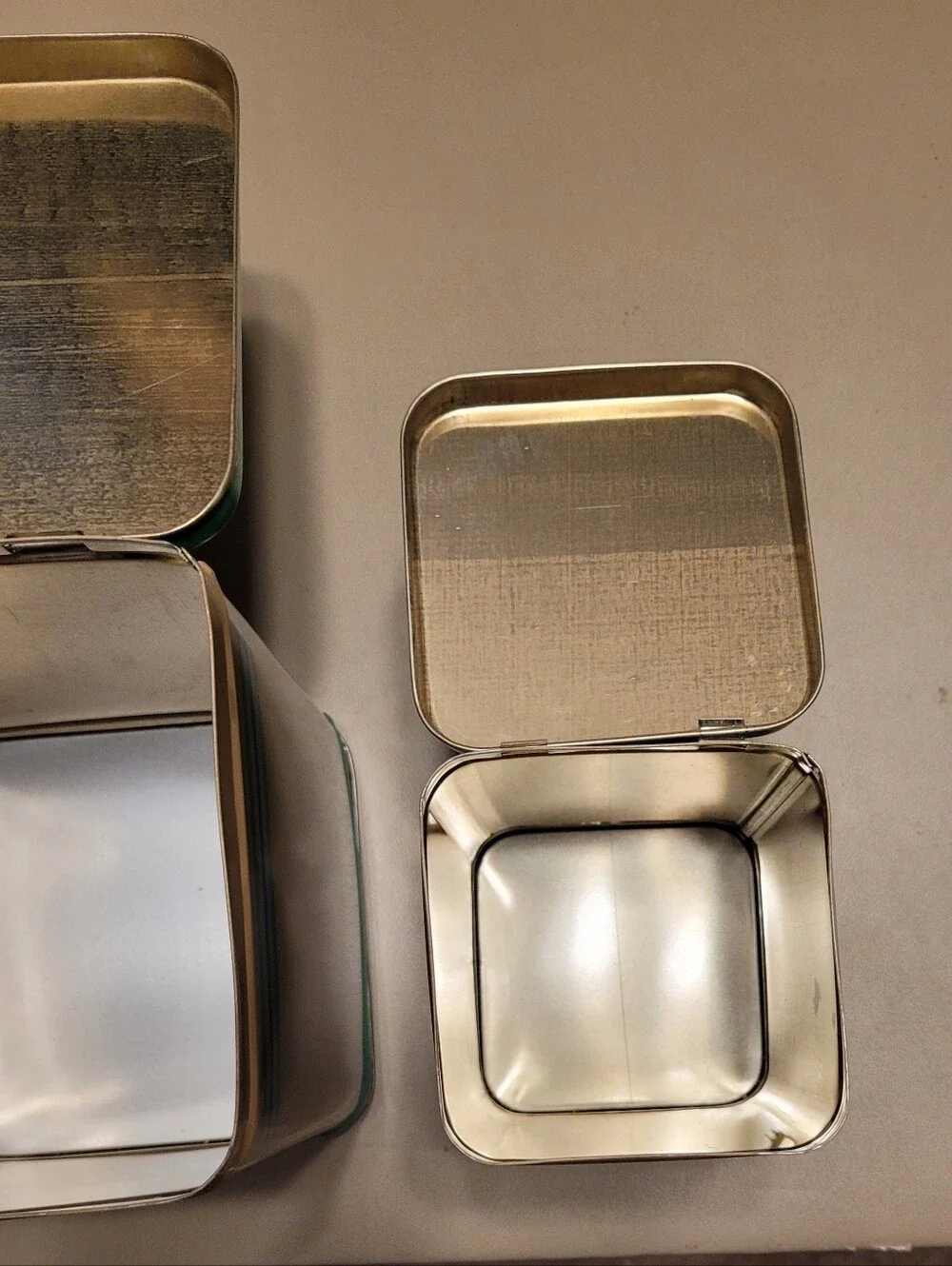 LASLO - Set of 3 Nesting Tan Metal Canisters with Green Lids and Stripes.
